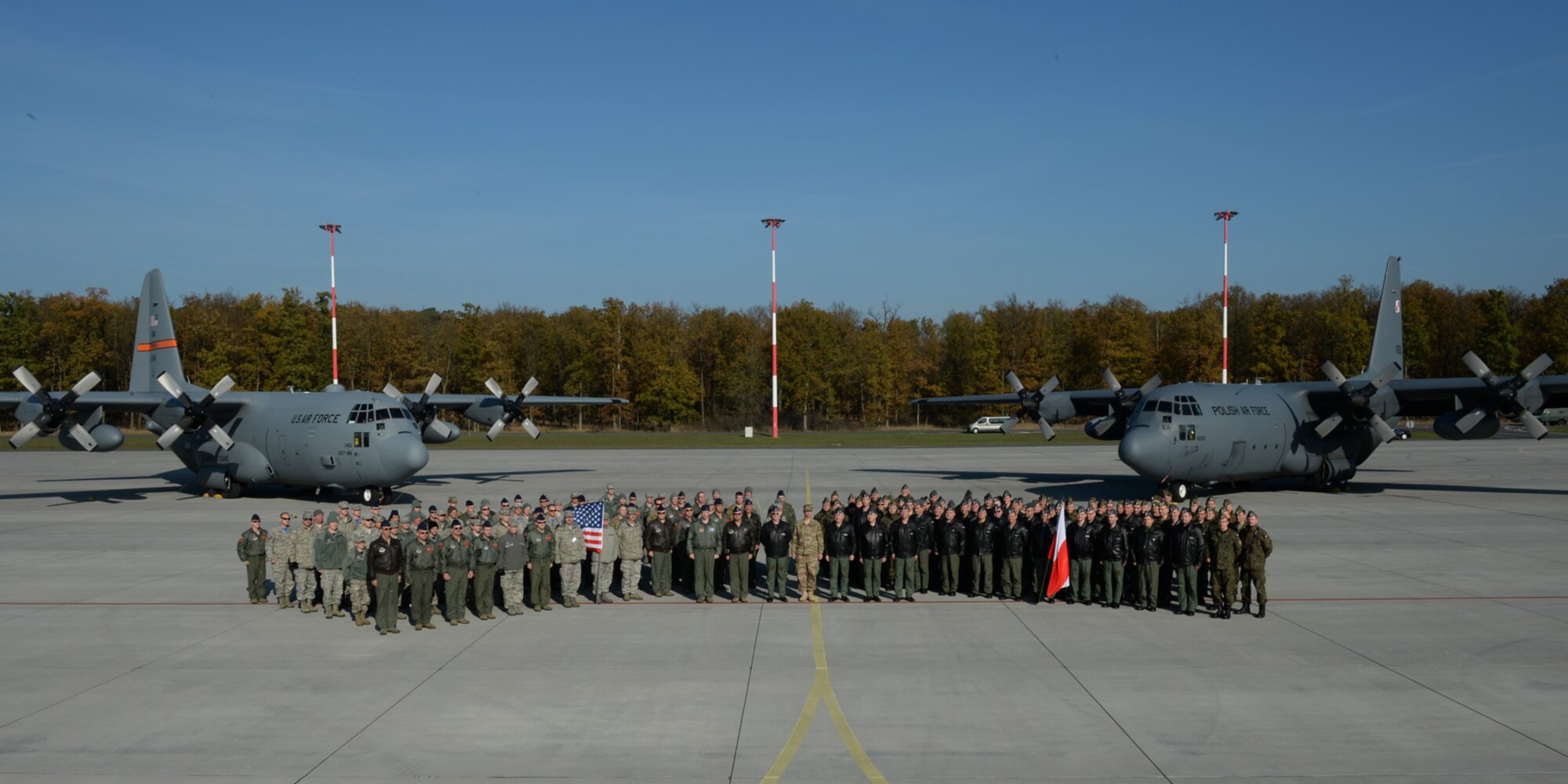 U.S. Air Force Airmen assigned to the 182nd Airlift Wing, Illinois Air National Guard, Peoria, Ill., and Detachment 1, 52nd Operations Group, from Lask Air Base, Poland, and Polish airmen assigned to the33rd Transportation Air Base pose for a group photo after a training mission Oct. 24, 2014, at Powidz Air Base, Poland. The 182nd AW supported rotation 15-1 hosted by the Aviation Detachment. The U.S. Air Force’s forward presence in Europe allows allies and partners to develop and improve ready air forces capable of maintaining regional security. (U.S. Air Force photo by Airman 1st Class Dylan Nuckolls/Released)