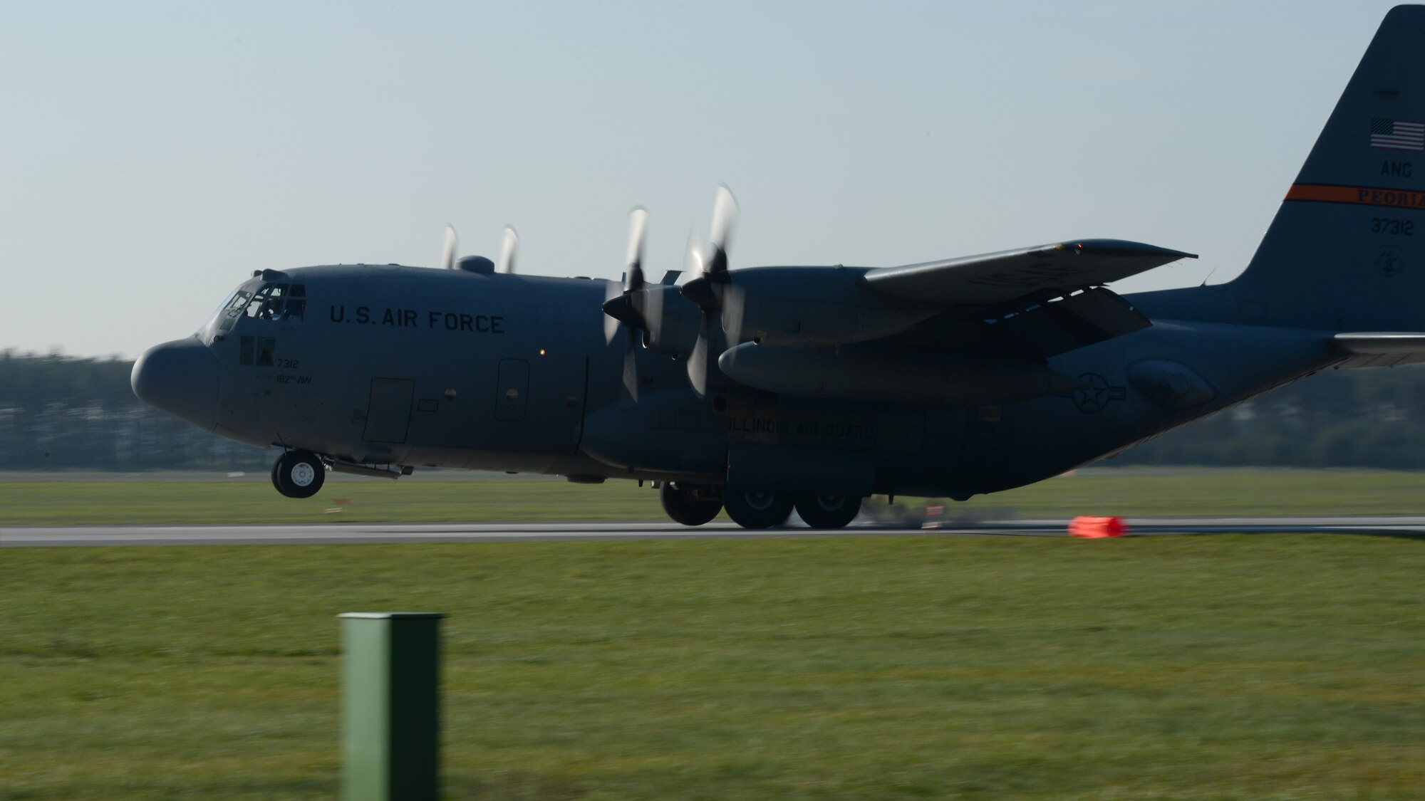 A U.S. Air Force C-130 Hercules cargo aircraft pilot performs a tactical landing during a “turkey shoot” training mission Oct. 24, 2014, at Powidz Air Base, Poland. Tactical landings consist of touchdowns on short or unimproved runways in tight and remote areas where supplies might be needed. The 182nd Airlift Wing, Illinois Air National Guard, Peoria, Ill., supported rotation 15-1 hosted by the U.S. Air Force Aviation Detachment 1, 52nd Operations Group, Lask Air Base, Poland. The U.S. Air Force’s forward presence in Europe allows allies and partners to develop and improve ready air forces capable of maintaining regional security.  (U.S. Air Force photo by Airman 1st Class Dylan Nuckolls/Released)