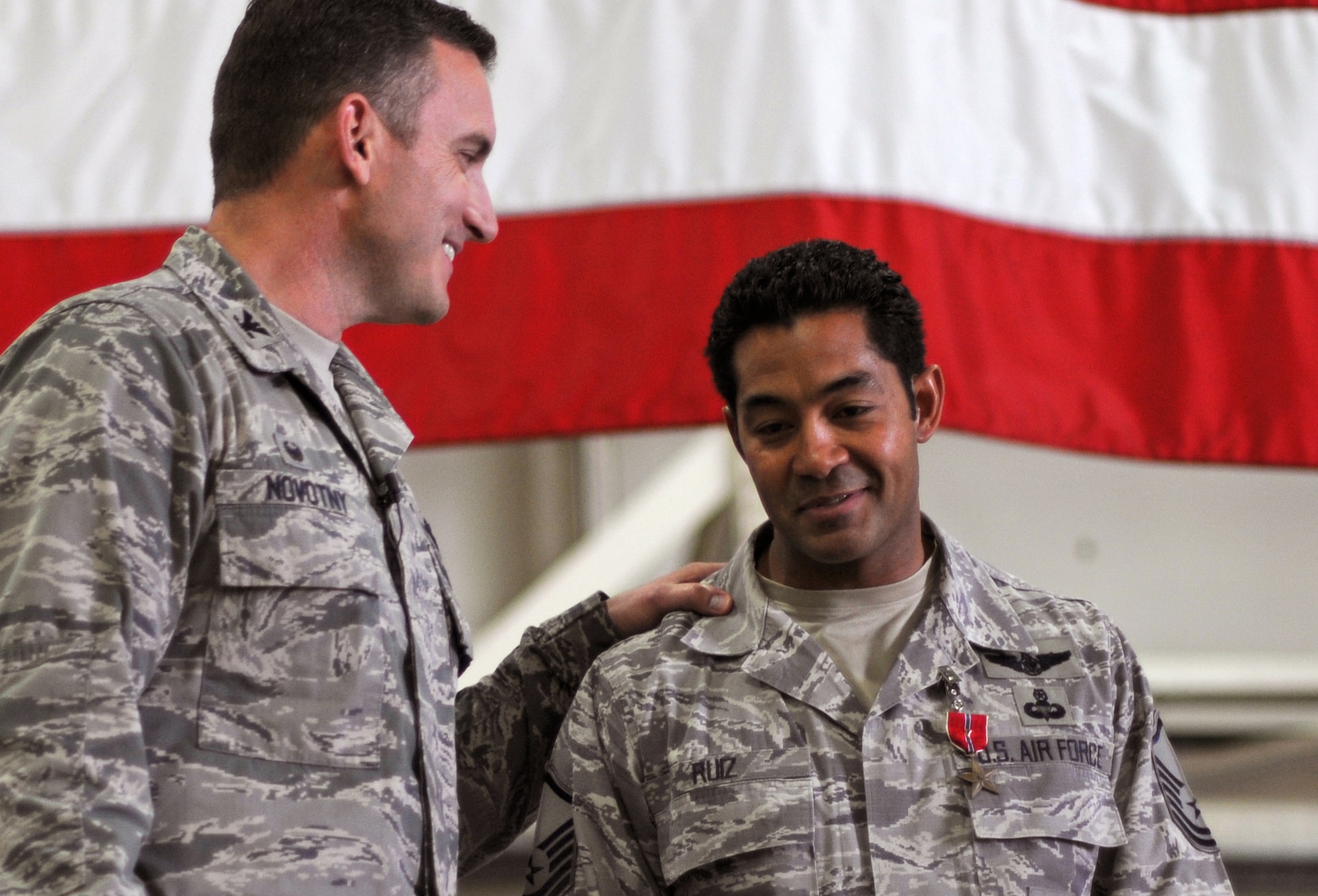 Col. Robert Novotny, 48th Fighter Wing commander, congratulates Master Sgt. Ivan Ruiz, 56th Rescue Squadron pararescueman, after presenting the Bronze Star Medal for Heroism at Royal Air Force Lakenheath, England, Oct. 27, 2014. Ruiz was awarded the medal for his courageous acts of heroism involving engagement in action against enemy forces in Afghanistan in September 2013. (U.S. Air Force photo by Senior Airman Erin O’Shea/Released) 