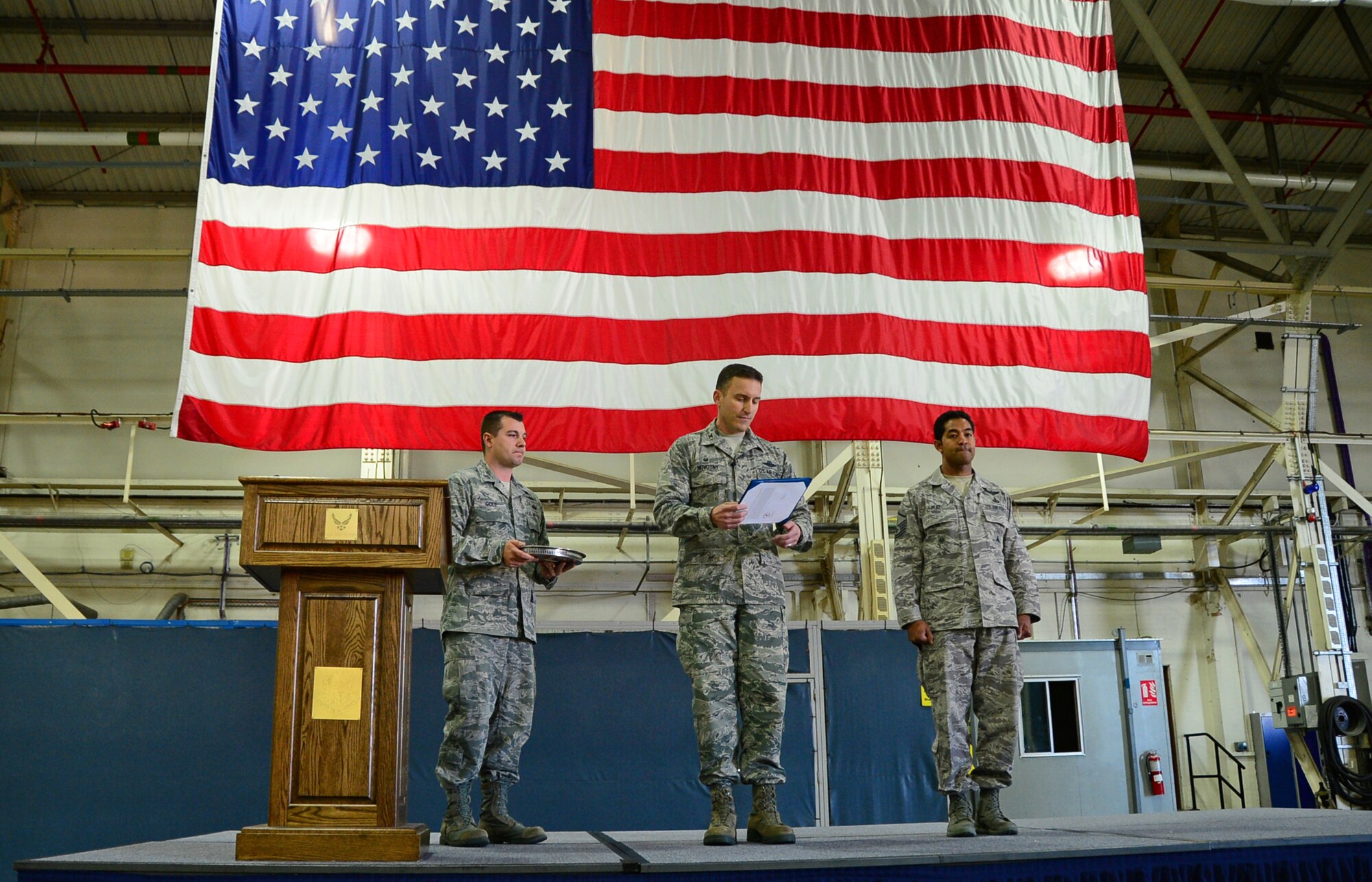 Col. Robert Novotny, 48th Fighter Wing commander, reads a Bronze Star Medal for Heroism citation to recipient Master Sgt. Ivan Ruiz, 56th Rescue Squadron pararescueman, right, before a commander’s call at Royal Air Force Lakenheath, England, Oct. 27, 2014. Ruiz distinguished himself by performing valorous and heroic acts while he was deployed to Afghanistan in September 2013, where he employed courageous leadership skills to suppress enemy forces. (U.S. Air Force photo by Senior Airman Erin O’Shea/Released)
