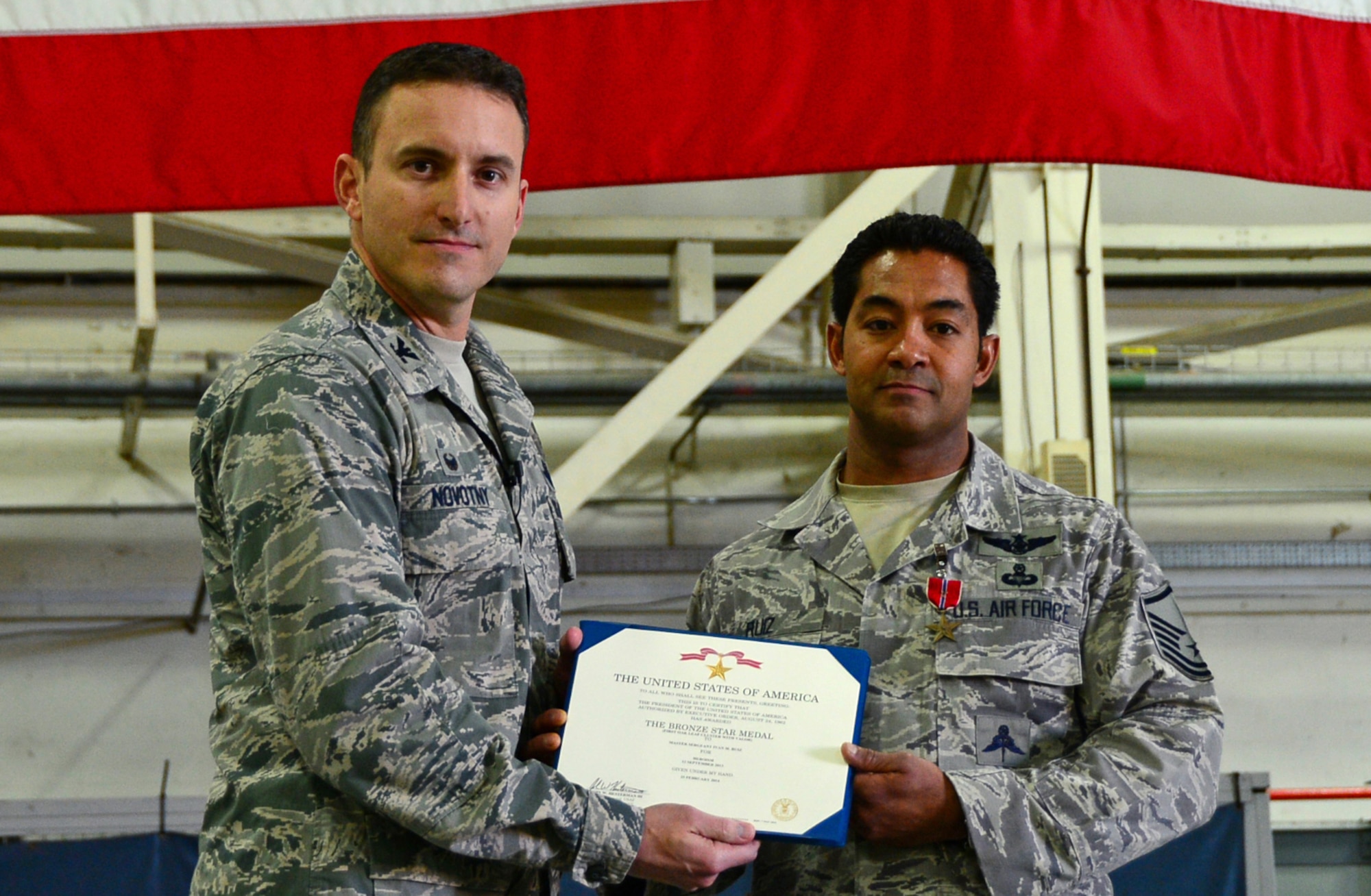 Col. Robert Novotny, 48th Fighter Wing commander, presents the Bronze Star Medal for Heroism to Master Sgt. Ivan Ruiz, 56th Rescue Squadron pararescueman, before a commander’s call at Royal Air Force Lakenheath, England, Oct. 27, 2014. Ruiz was awarded the medal for his courageous acts of heroism involving engagement in action against enemy forces in Afghanistan in September 2013. (U.S. Air Force photo by Senior Airman Erin O’Shea/Released) 