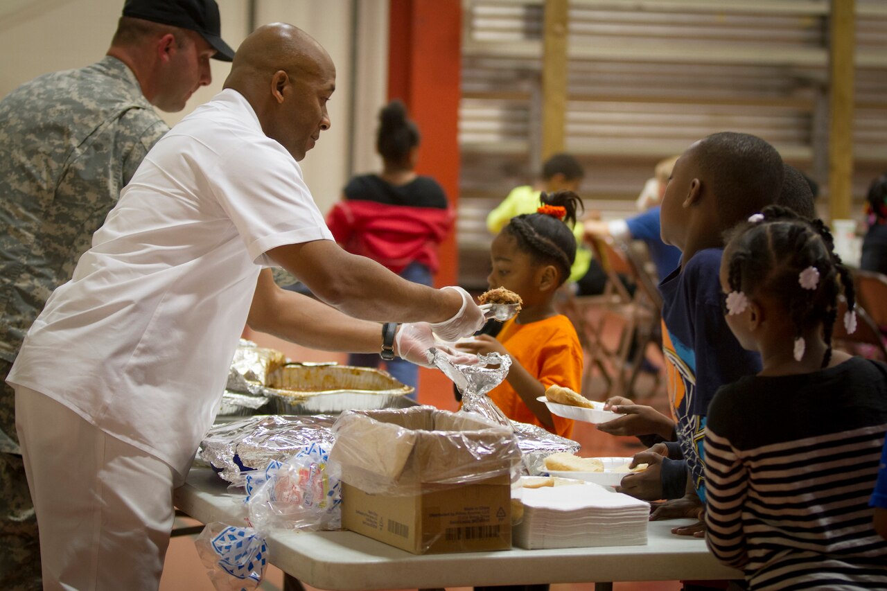 Army Sgt. 1st Class Christopher Roberts serves food to children at the Boys and Girls Club of America in Christian County, Ky., Oct. 21, 2014, where he volunteers. U.S. Army photo by Sgt. Justin A. Moeller