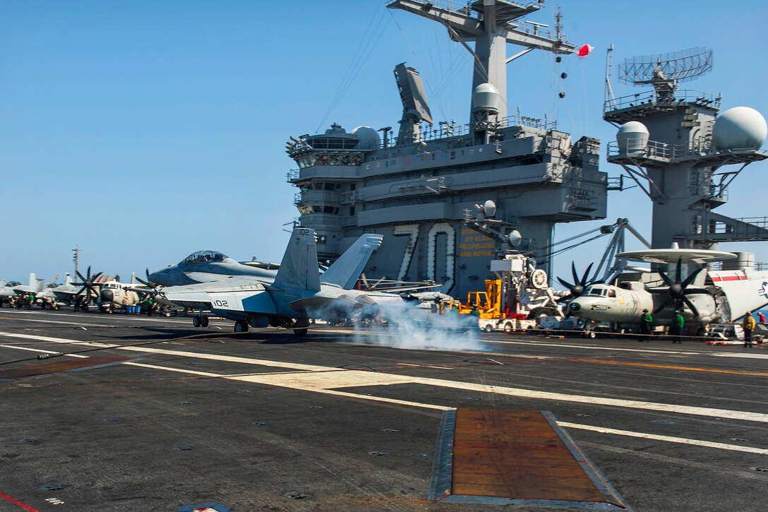 An F/A-18F Super Hornet from Strike Fighter Squadron 22 makes an arrested recovery on the flight deck of the Nimitz-class aircraft carrier USS Carl Vinson as the ship conducts flight operations in the U.S. 5th Fleet area of operations supporting Operation Inherent Resolve, Oct. 19, 2014.