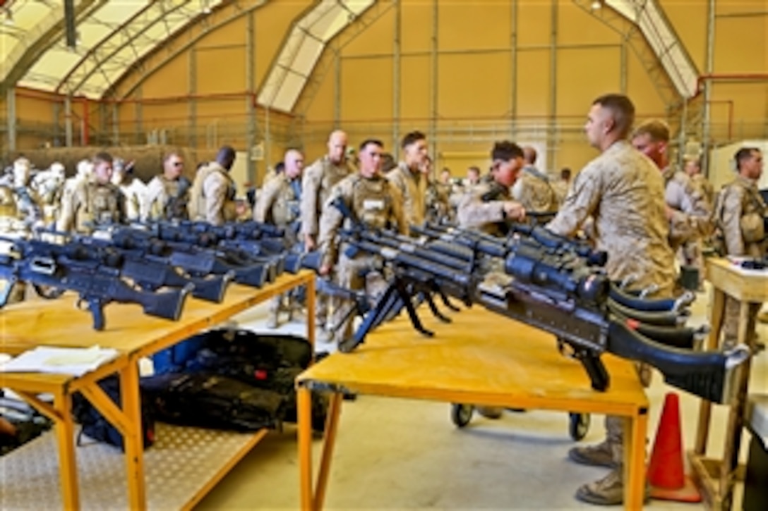 U.S Marines turn in their M240B machine guns on Kandahar Airfield in Afghanistan following the end of Regional Command Southwest operations in Helmand province, Oct. 27, 2014.
