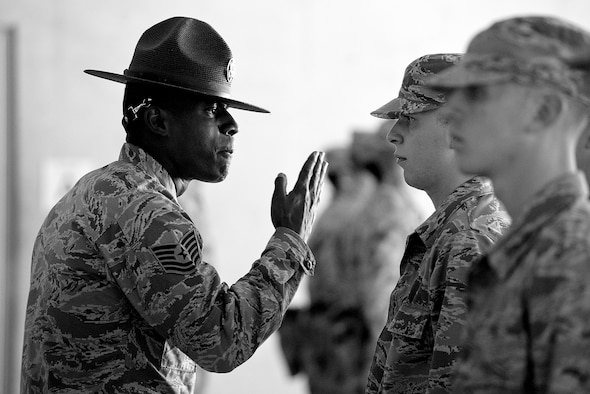 A military training instructor gives instruction to a trainee and his wingman during a formation at Joint Base San Antonio - Lackland, Texas. (U.S. Air Force photo/Master Sgt. Jeffrey Allen)