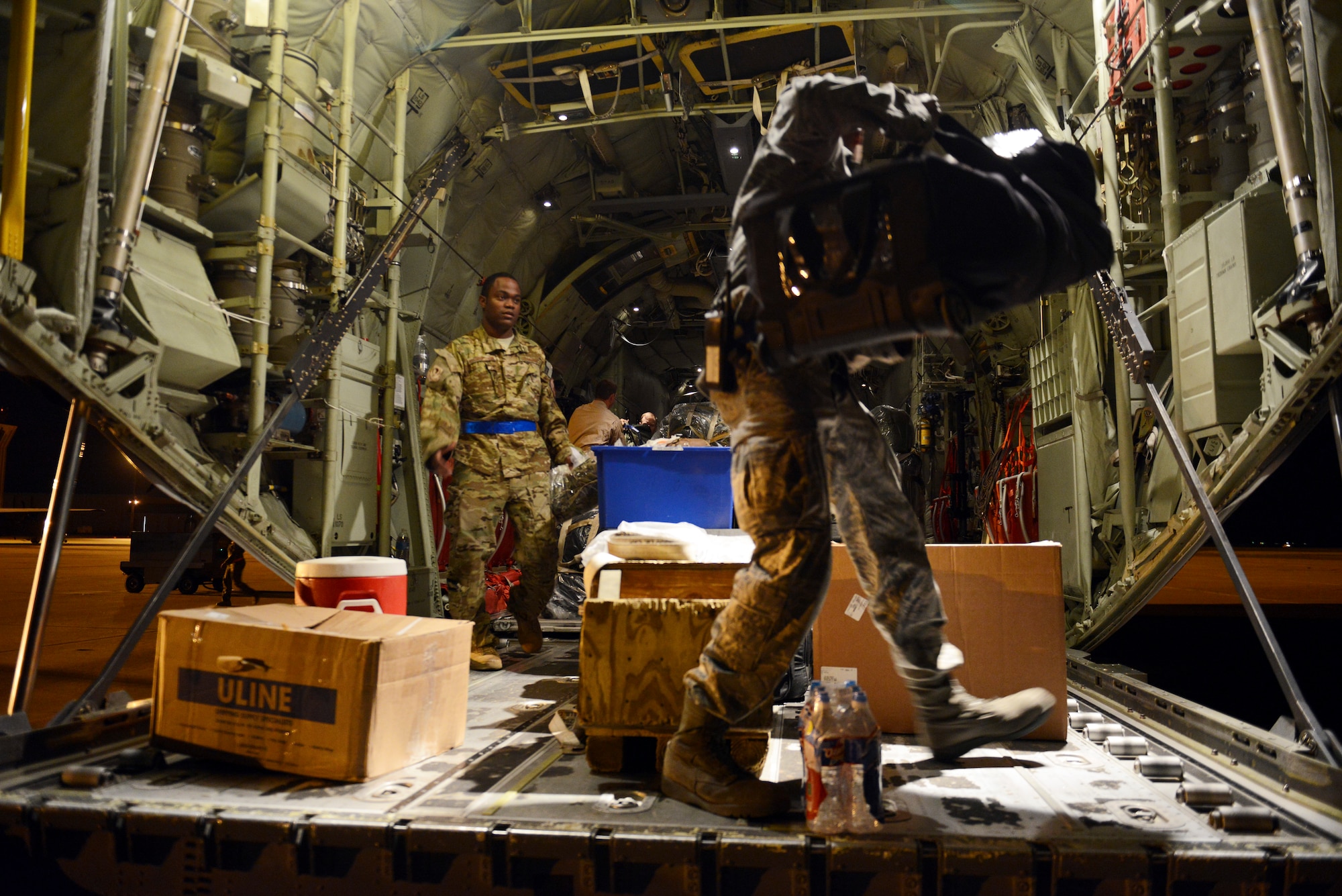 U.S. Airmen load luggage and supplies aboard a C-130J Super Hercules before deploying from Dyess Air Force Base, Texas, Oct. 29, 2014, in support of Operation United Assistance. The deployment, which is expected to last approximately 120 days, will not require Dyess Airmen to treat or transport persons stricken with the Ebola virus, or healthcare workers who have had direct contact with Ebola patients. Instead, the mission requirements focus on moving cargo and needed supplies to support U.S. interagency partners in their collective response to the outbreak in West Africa. (U.S. Air Force photo by Airman 1st Class Kedesha Pennant)