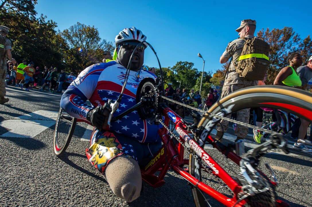 Marines welcome runners as they near the finish line during Sunday’s 39th Annual Marine Corps Marathon. 