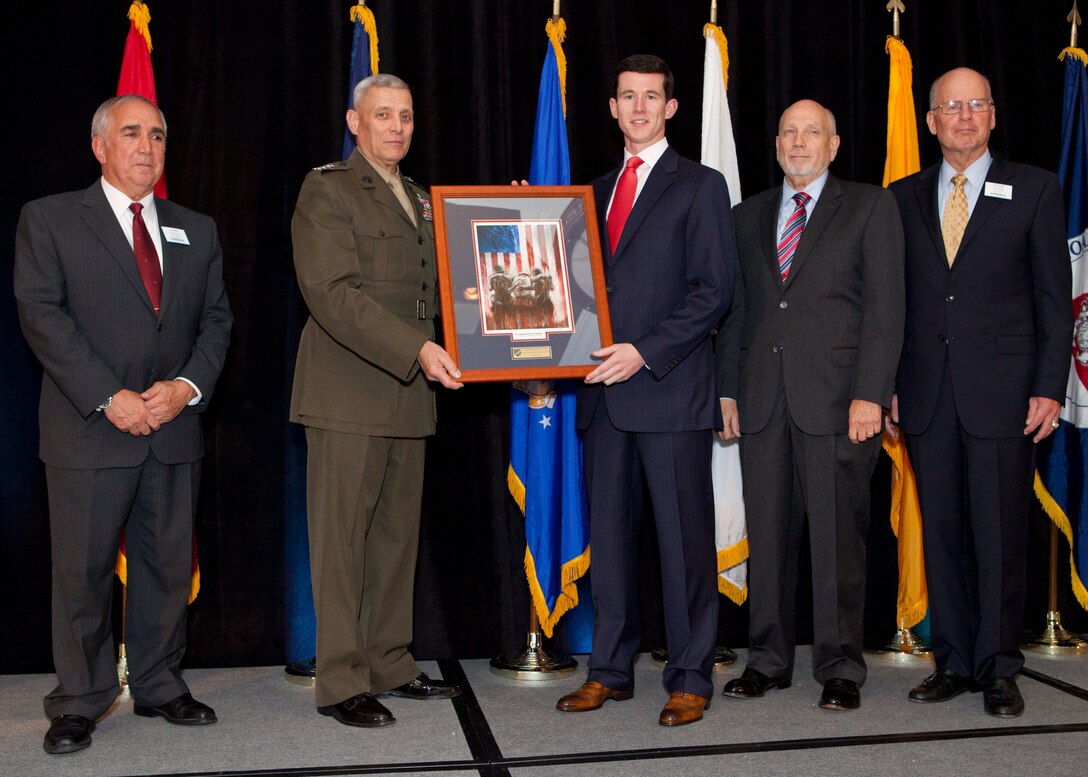 The Assistant Commandant of the Marine Corps, Gen. John M. Paxton, Jr., second from left, poses for a photo during the Military Officers Association of America 2014 Community Heroes Awards Dinner in Arlington, Va., Oct. 28, 2014. This year the award recognizes both individuals and groups within military and civilian communites in the national capital region who exemplify service to the wounded military and veterans' populations. (U.S. Marine Corps photo by Cpl. Tia Dufour/Released)
