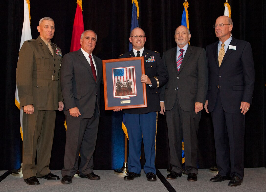 The Assistant Commandant of the Marine Corps, Gen. John M. Paxton, Jr., left, poses for a photo during the Military Officers Association of America 2014 Community Heroes Awards Dinner in Arlington, Va., Oct. 28, 2014. This year the award recognizes both individuals and groups within military and civilian communites in the national capital region who exemplify service to the wounded military and veterans' populations. (U.S. Marine Corps photo by Cpl. Tia Dufour/Released)