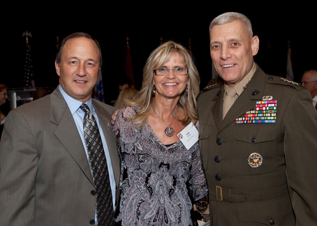 The Assistant Commandant of the Marine Corps, Gen. John M. Paxton, Jr., right, poses for a photo during the Military Officers Association of America 2014 Community Heroes Awards Dinner in Arlington, Va., Oct. 28, 2014. This year the award recognizes both individuals and groups within military and civilian communites in the national capital region who exemplify service to the wounded military and veterans' populations. (U.S. Marine Corps photo by Cpl. Tia Dufour/Released)