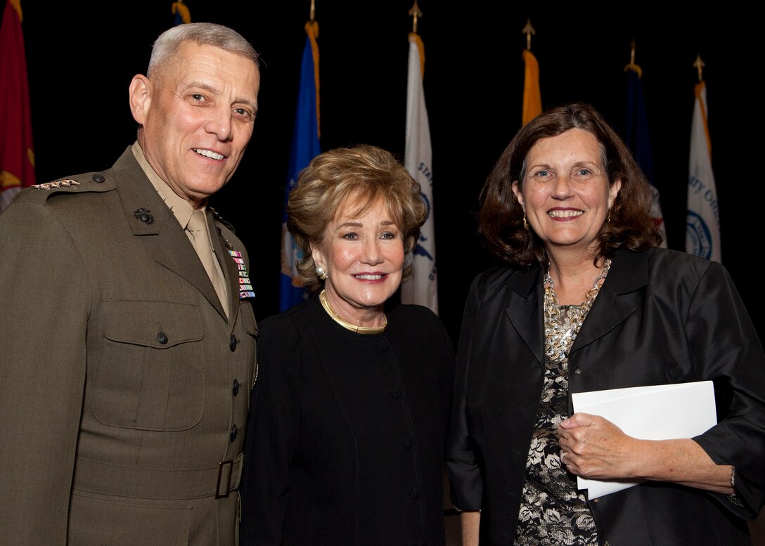 From the left, the Assistant Commandant of the Marine Corps, Gen. John M. Paxton, Jr.; Senator Elizabeth Dole; and Debbie Paxton, pose for a photo during the Military Officers Association of America 2014 Community Heroes Awards Dinner in Arlington, Va., Oct. 28, 2014. This year the award recognizes both individuals and groups within military and civilian communites in the national capital region who exemplify service to the wounded military and veterans' populations. (U.S. Marine Corps photo by Cpl. Tia Dufour/Released)