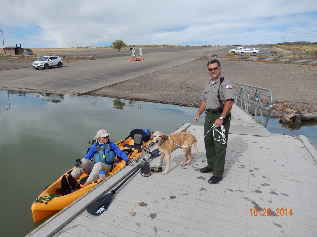COCHITI LAKE, N.M., -- Park Ranger Adrian Glass holds the leash of the dog picked up by the kayaker, Oct. 28.  
 