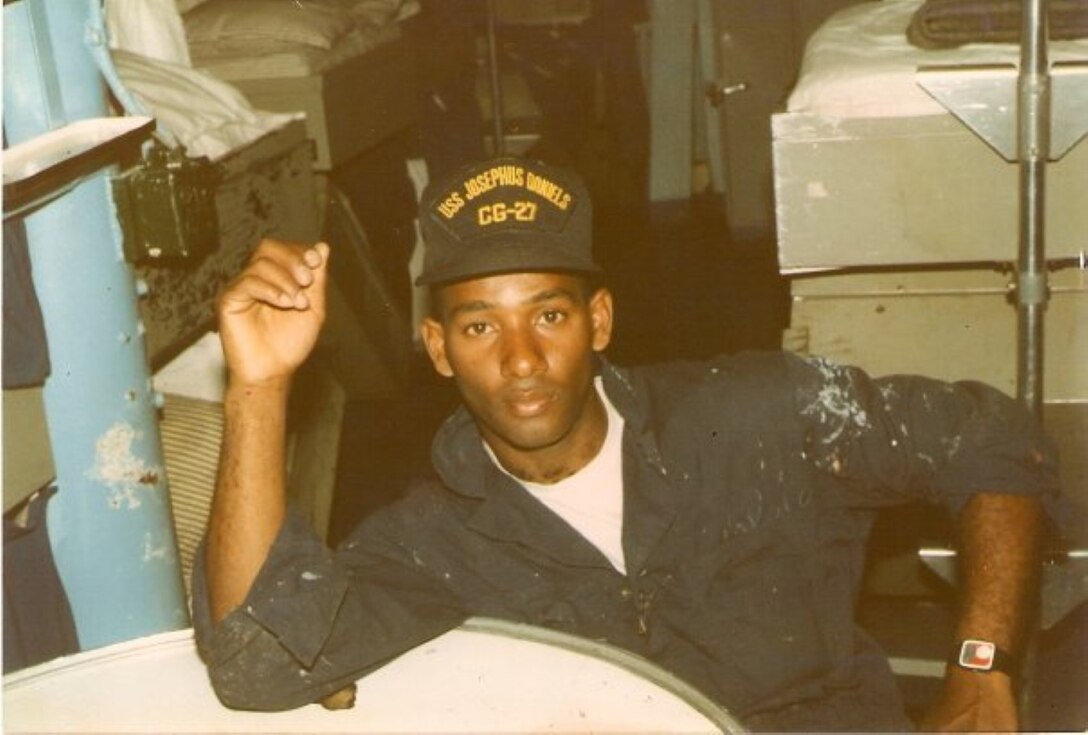 U.S Navy Seaman Samuel Revelo takes a break after a hot day aboard the USS Josephus Daniels. (Courtesy photo circa 1986/Released)