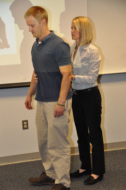 WINCHESTER, Va. - Dr. Melissa Jennings, Winchester Phyiscal Therapy and Sports Medicine, Inc., and employee Joey Behr demonstrate correct posture during the Helath Promotions Committee's brown bag luncheon Oct. 29. 