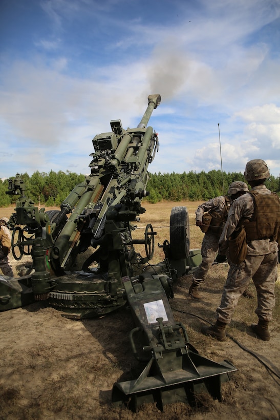 Artillery Marines of Gun 3, Battery A, Ground Combat Element Integrated Task Force, fire a round down range from an M777A2 Lightweight Howitzer during a fire mission at Marine Corps Base Camp Lejeune, North Carolina, Oct. 29, 2014. Marines of Battery A conducted a live-fire artillery shoot, Oct. 28-30, 2014. From October 2014 to July 2015, the GCEITF will conduct individual and collective level skills training in designated ground combat arms occupational specialties in order to facilitate the standards based assessment of the physical performance of Marines in a simulated operating environment performing specific ground combat arms tasks. (U.S. Marine Corps photo by Sgt. Alicia R. Leaders/Released)