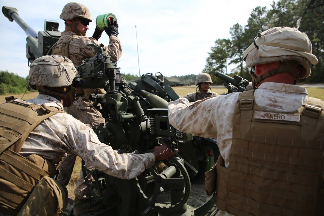 Artillery Marines with Gun 3, Battery A, Ground Combat Element Integrated Task Force, prepare to send a round down range during a fire mission at Marine Corps Base Camp Lejeune, Oct. 29, 2014. Marines of Battery A conducted a live-fire artillery shoot, Oct. 28-30, 2014. From October 2014 to July 2015, the GCEITF will conduct individual and collective level skills training in designated ground combat arms occupational specialties in order to facilitate the standards based assessment of the physical performance of Marines in a simulated operating environment performing specific ground combat arms tasks. (U.S. Marine Corps photo by Sgt. Alicia R. Leaders/Released)