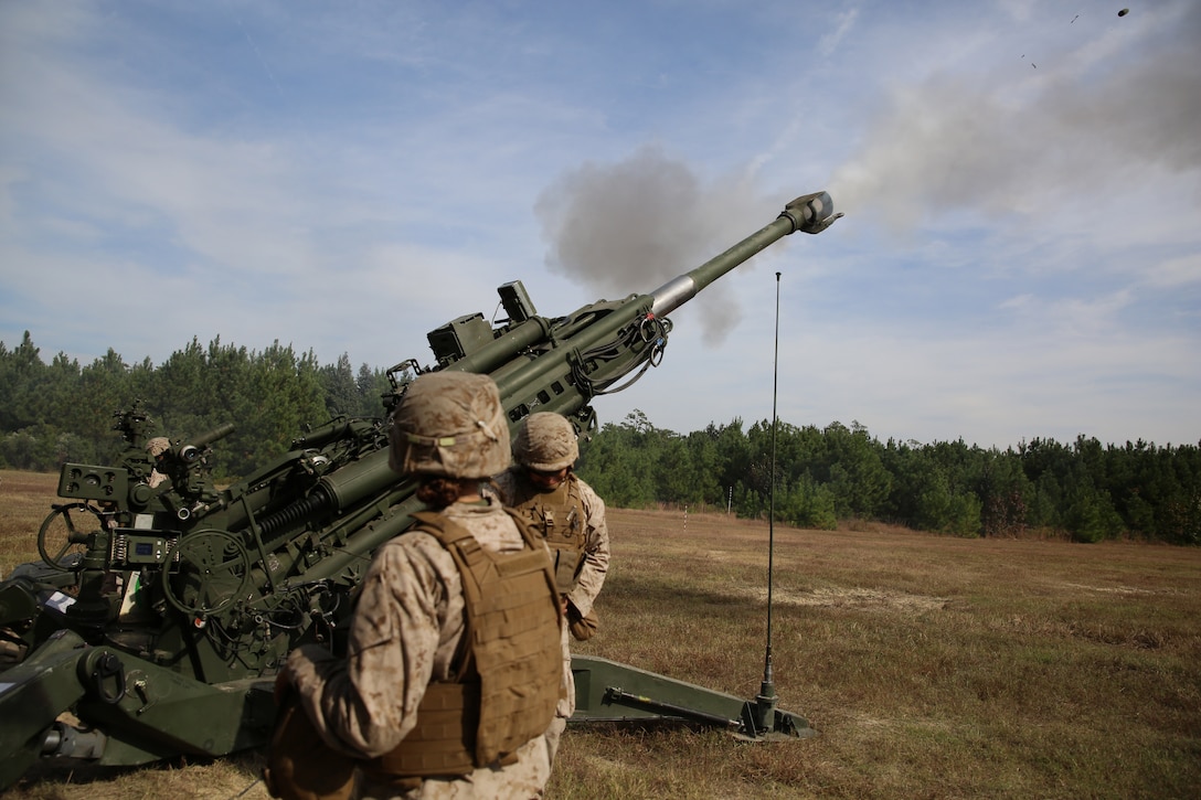 Artillery Marines with Battery A, Ground Combat Element Integrated Task Force, send rounds down range during a live-fire artillery shoot at Marine Corps Base Camp Lejeune, North Carolina, Oct. 29, 2014. Marines of Battery A conducted a live-fire artillery shoot, Oct. 28-30, 2014. From October 2014 to July 2015, the GCEITF will conduct individual and collective level skills training in designated ground combat arms occupational specialties in order to facilitate the standards based assessment of the physical performance of Marines in a simulated operating environment performing specific ground combat arms tasks. (U.S. Marine Corps photo by Sgt. Alicia R. Leaders/Released)