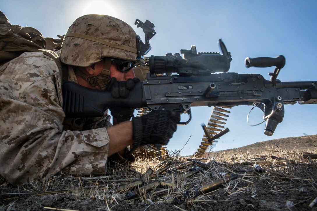 A U.S. Marine with Lima Company, Battalion Landing Team 3rd Battalion, 1st Marine Regiment, 15th Marine Expeditionary Unit, provides suppressive fire during a vertical assault raid exercise aboard Camp Pendleton, Calif., Oct. 28, 2014. BLT 3/1 is the 15th MEU’s ground combat element. (U.S. Marine Corps photo by Sgt. Emmanuel Ramos/Released)