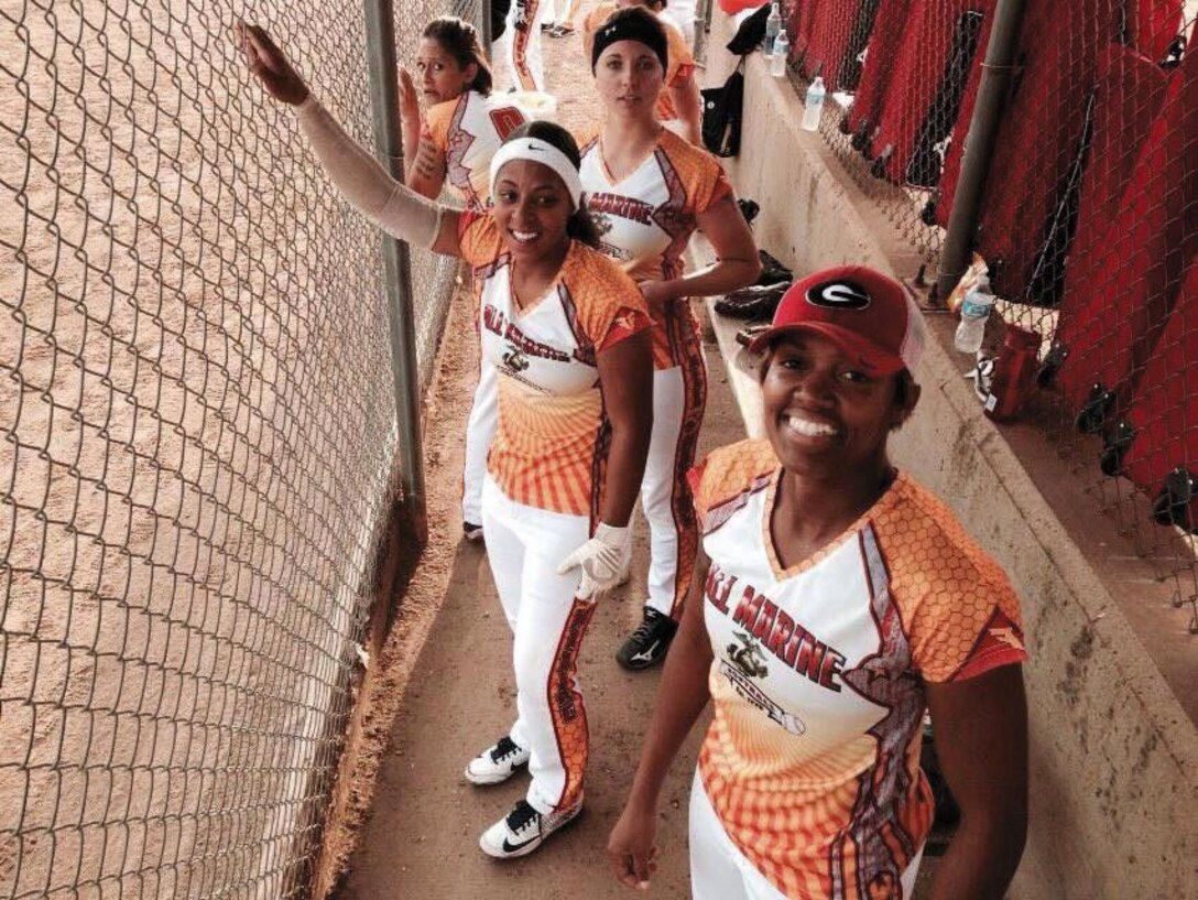 Sgt. Candice Clark (right) stands in the dugout with her All-Marine softball teammates Lance Cpl. Vanessa Crump (second right), Cpl. Rebecca Trimmer (third right) and Sgt. Aisha Shapiro-Kinghorn.