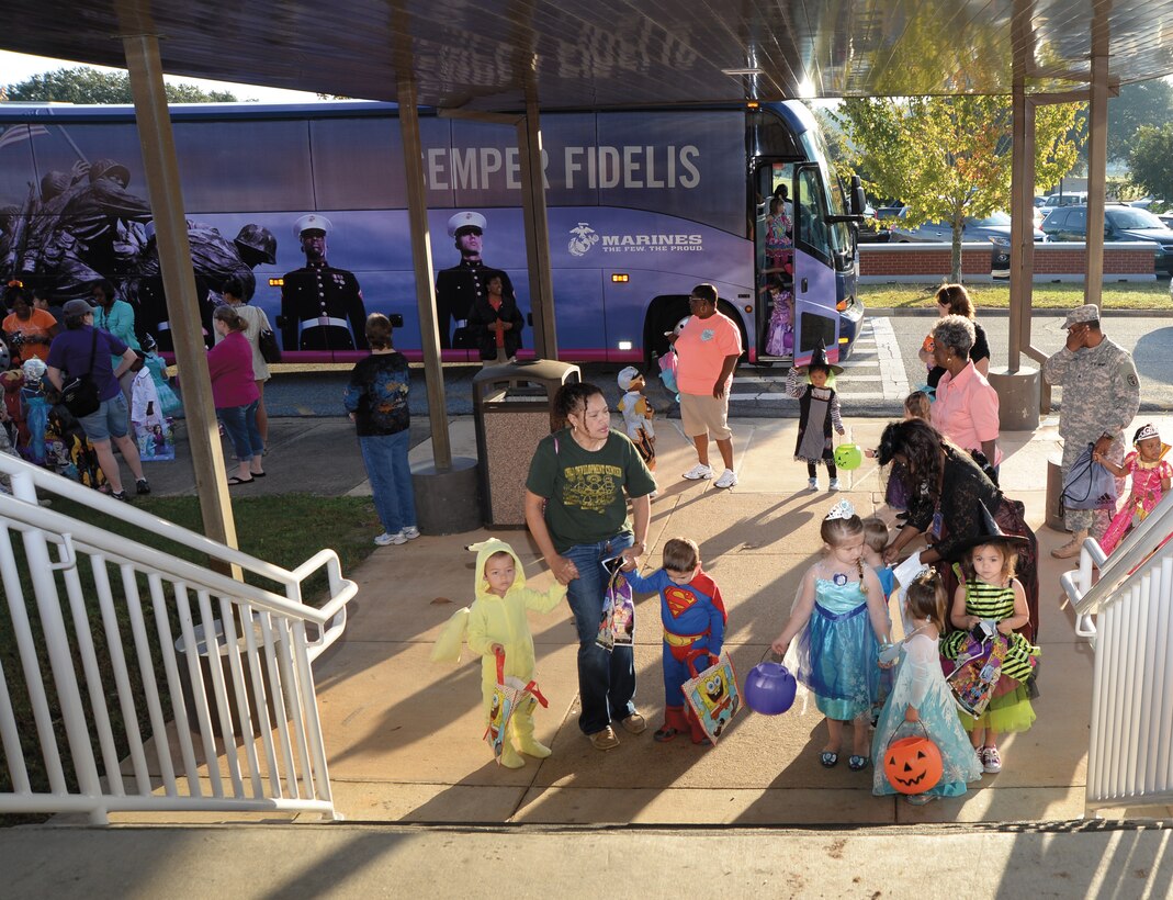 Children from the Child Development Center arrive at Building 3500 to parade down its hallway for Halloween treats.