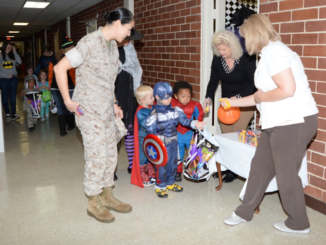 Superheroes, ghosts and goblins converge upon Marine Corps Logistics Base Albany, Wednesday. Capt. Monica Laux escorted three tikes to various offices in Building 3500 to collect treats.