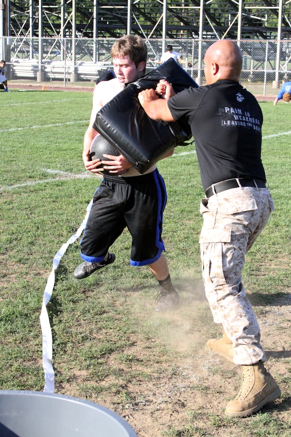 Sgt. Jose Murillo, (right) defends a goal during a leadership seminar at Danvers High School Sept. 18, 2014. The seminars conducted by Marine Corps Recruiting Station Portsmouth, N.H. are a part of an initiative to spread the word about Marine Corps leadership in an attempt to mentor young high school and college students across New England. Murillo moved to Waltham, Massachusetts from Bolivia. “The one thing I told my mother growing up is that one day I will take care of you,” Murillo said about his mother’s decision to move her family to the states after a tough stretch in Bolivia. Since arriving on recruiting duty in August 2013 Murillo has done just that by having his mother, Maria, move in with him. 
