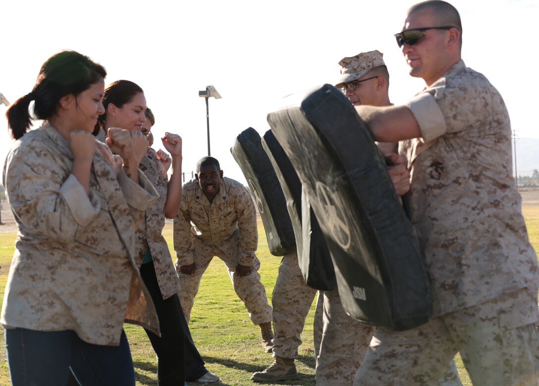 Combat Center spouses utilize their Marine Corps Martial Arts Program training during a Jane Wayne day for 7th Marine Regiment aboard the Combat Center, Oct. 8, 2014. Spouses were able to gain a glimpse into the life of their Marine. (Photo by Pfc. Medina Ayala-Lo)