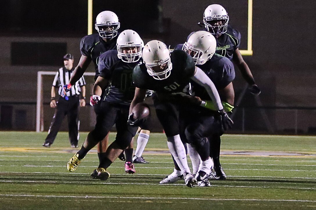 The Marine Corps Base Spartans secured their spot in the semi-finals with a dominant 38-0 win over the School of Infantry Outlaws during their first game of the playoffs here, Oct. 27.