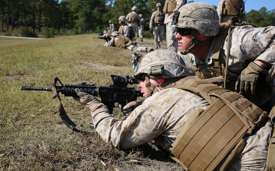 Sgt. Damien Hall, right, rifleman with Company A, Ground Combat Element Integrated Task Force, observes impacted targets of Sgt. Kyle W. Stubbeman, rifleman with Co. A, GCEITF, during a live-fire shoot where Marines engaged targets at an unknown distance with an elevated heart rate at Marine Corps Base Camp Lejeune, North Carolina, Oct. 30, 2014.  Marines with Company A and B, Battery A, and Weapons Company conducted live-fire training, Oct. 28-30, 2014, to familiarize themselves with the weapon systems. From October 2014 to July 2015, the GCEITF will conduct individual and collective level skills training in designated ground combat arms occupational specialties in order to facilitate the standards based assessment of the physical performance of Marines in a simulated operating environment performing specific ground combat arms tasks. 