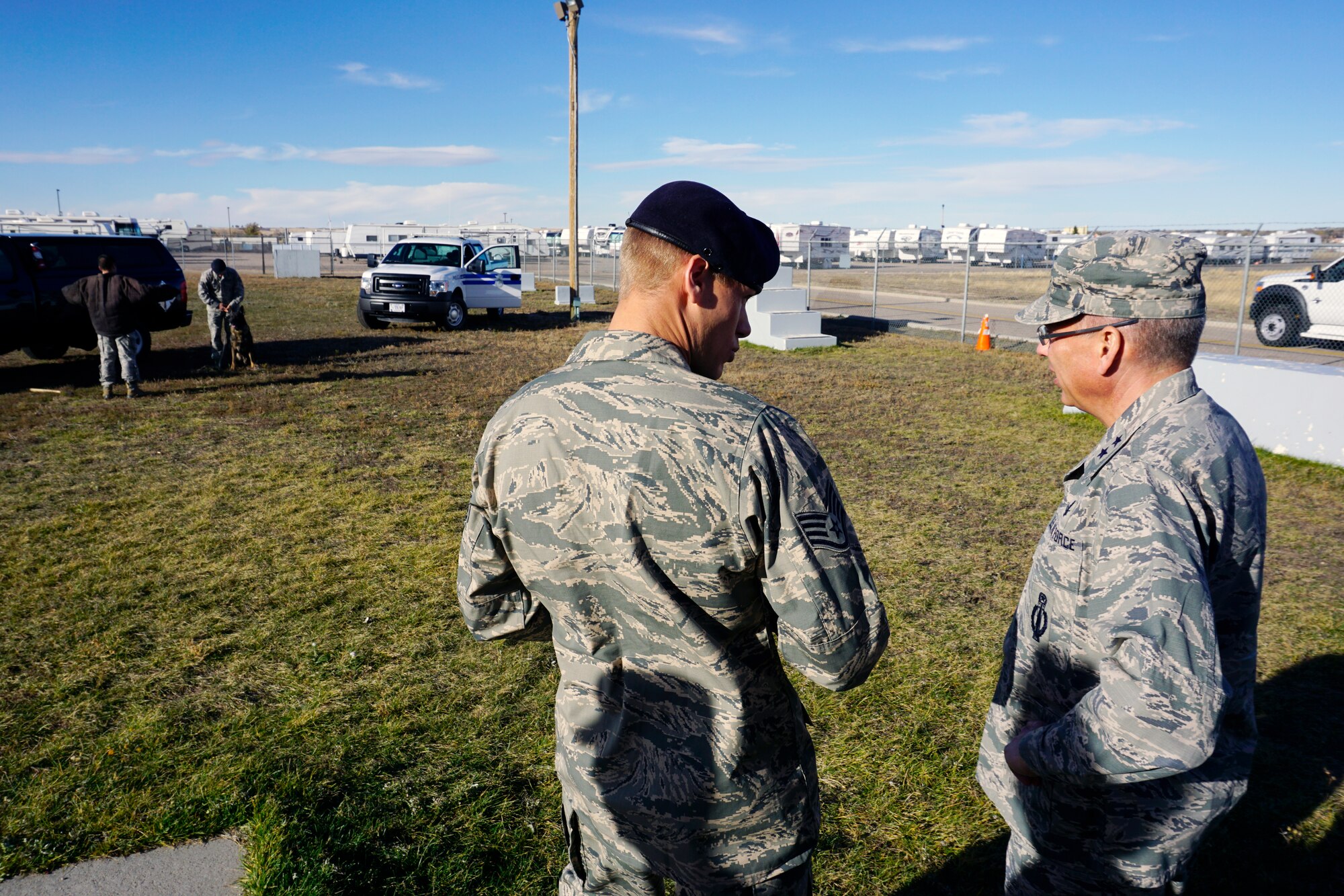 Maj. Gen. Jack Weinstein, Task Force 214 and 20th Air Force commander, and Staff Sgt. Brandon Durham, 90th Security Forces Squadron, discuss the tactics and procedures of the military working dog demonstration Oct. 28, 2014, on F.E. Warren Air Force Base, Wyo. Weinstein visited  the MWD kennels to get a glimpse of the conditions in which the MWDs train.  (U.S. Air Force photo by Lan Kim)
