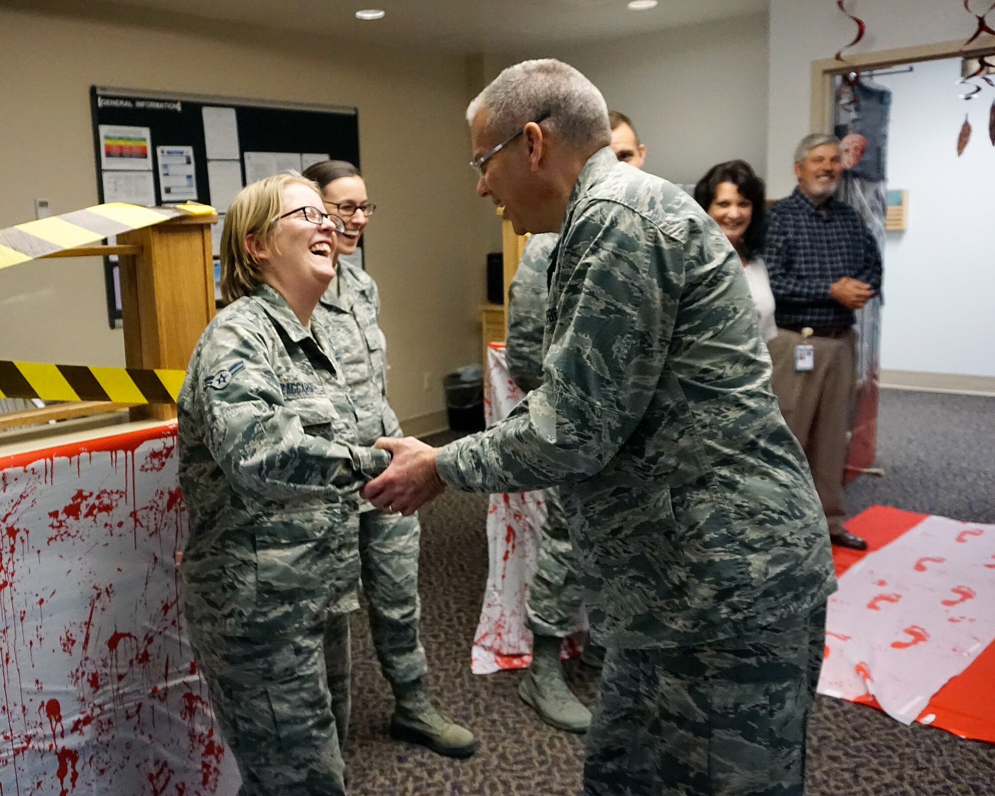 Maj. Gen. Jack Weinstein, Task Force 214 and 20th Air Force commander, greets Airman 1st Class Jennifer Zaccardi, 90th Medical Operations  Squadron Oct. 28, 2014, on F.E. Warren Air Force Base, Wyo. Weinstein visited the  90th Medical Group Medical Treatment Facility to get acquainted with the Airmen who maintain its daily operations.  (U.S. Air Force photo by Lan Kim)
