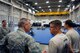 Staff Sgt. Justin Clark, 90th Security Support Squadron, converses with Maj. Gen. Jack Weinstein,  Task Force 214 and 20th Air Force commander, about the combatives training occurring before them Oct. 28, 2014, on F.E. Warren Air Force Base, Wyo. Weinstein visited the 90th Security Forces Group high bay to discuss model defender initiatives with security forces leadership. (U.S. Air Force photo by Lan Kim)
