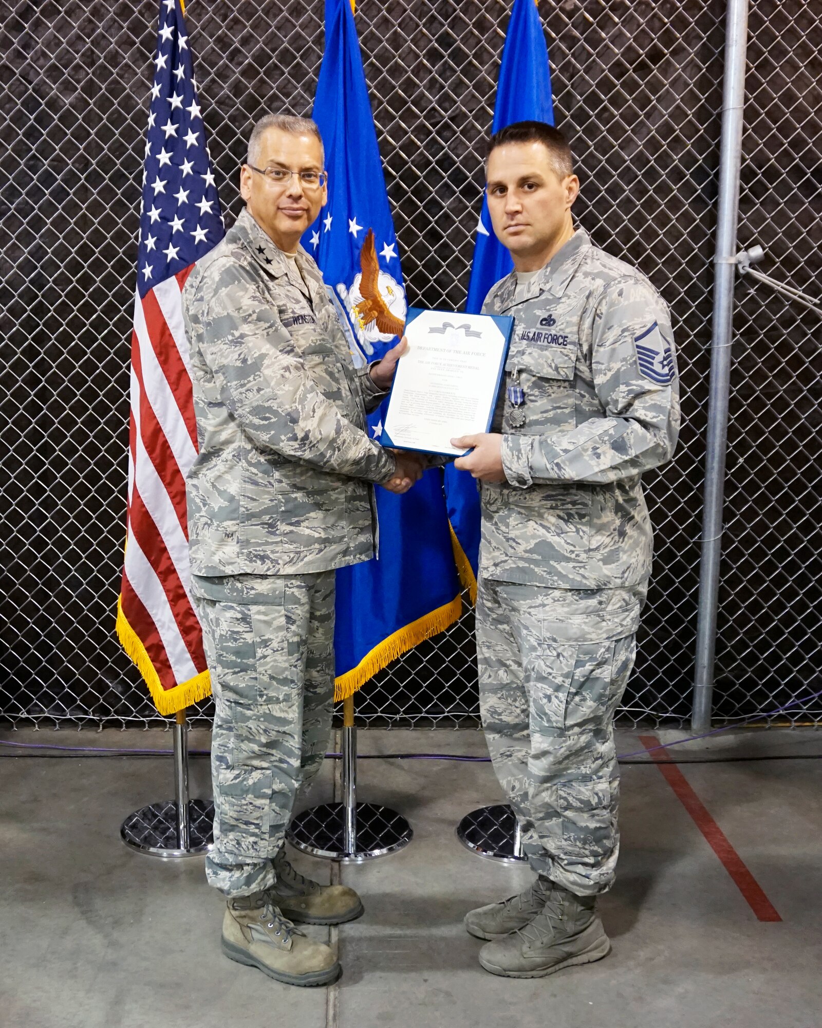 Maj. Gen. Jack Weinstein,  Task Force 214 and 20th Air Force commander, presents the Air Force Achievement Medal to Master Sgt. Adam Varga, 90th Logistics Readiness Squadron Oct. 27, 2014, on F.E. Warren Air Force Base, Wyo. The AFAM was awarded to Varga for providing his senior leadership insight and professional development to 25 company grade officers for a newly created flight commander's course. (U.S. Air Force photo by Lan Kim)
