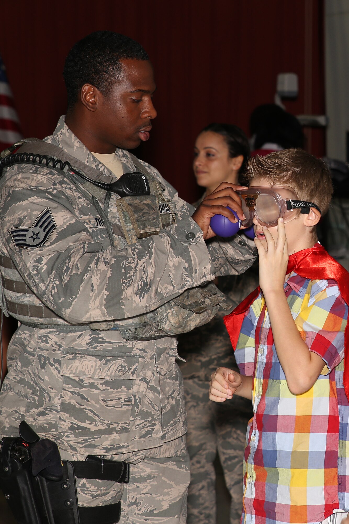 Staff Sgt. Fanciscus Thomas, 36th Security Forces Squadron Alpha Flight assistant chief, helps a student put on fatal vision goggles for a presentation Oct. 29, 2014, at Andersen Elementary School. Students and staff members were given the opportunity to participate in interactive field sobriety tests with 36th SFS Airmen while wearing the goggles to simulate vision impaired by drugs or alcohol.
(U.S. Air Force photo by Staff Sgt. Melissa B. White/Released)
