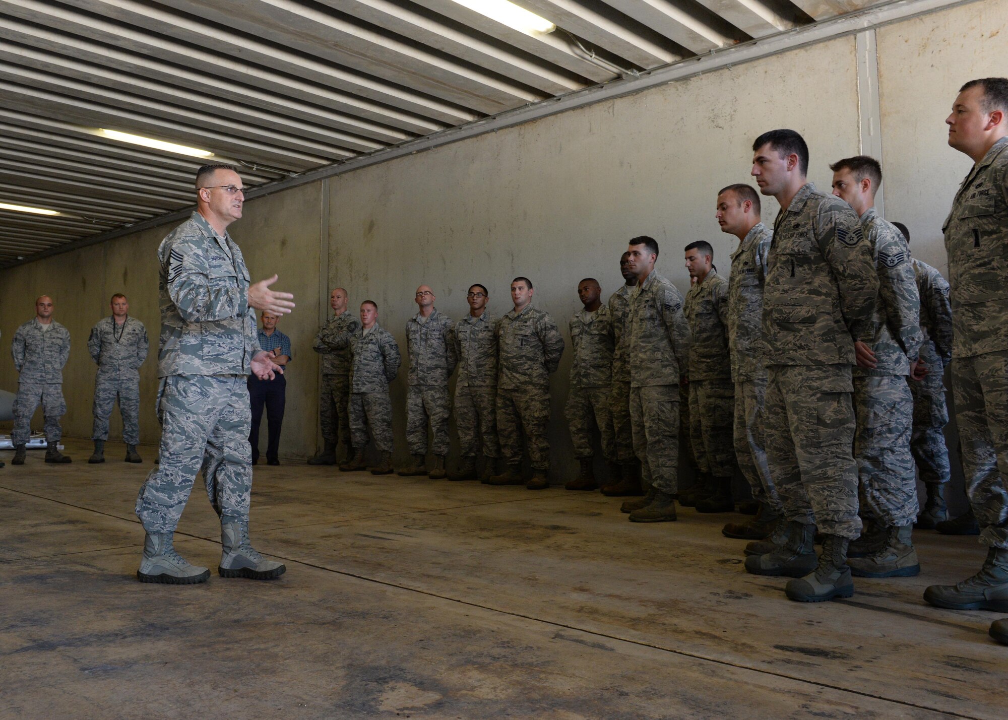 Chief Master Sgt. Harold Hutchison, Pacific Air Forces command chief master sergeant, visits with 36th Munitions Squadron Airmen Oct. 20, 2014, at Andersen Air Force Base, Guam. During his three day tour, Hutchison visited various facilities such as the Andersen Fire Department and the U.S. Navy's Helicopter Sea Combat Squadron 25. (U.S. Air Force photo by Senior Airman Katrina M. Brisbin/Released)