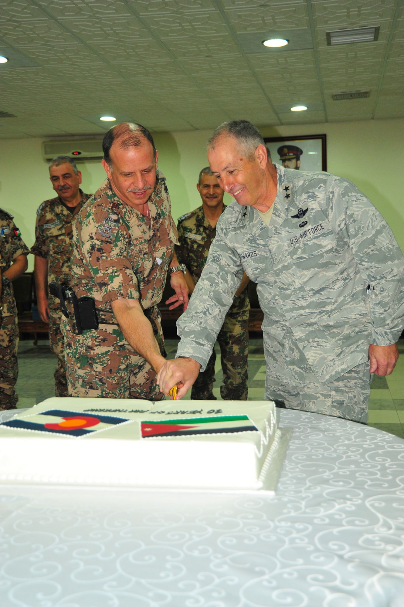 His Royal Highness Prince Feisal bin Al Hussein, of Jordan, and Maj. Gen. H. Michael Edwards, the Adjutant General of Colorado, celebrate the 10th Anniversary of the State Partnership Program relationship between the Colorado National Guard and the Hashemite Kingdom of Jordan at Mwafq Al-Salti Air Base, Jordan, May 14, 2014. (Army National Guard photo by 1st Lt. Skye Robinson)