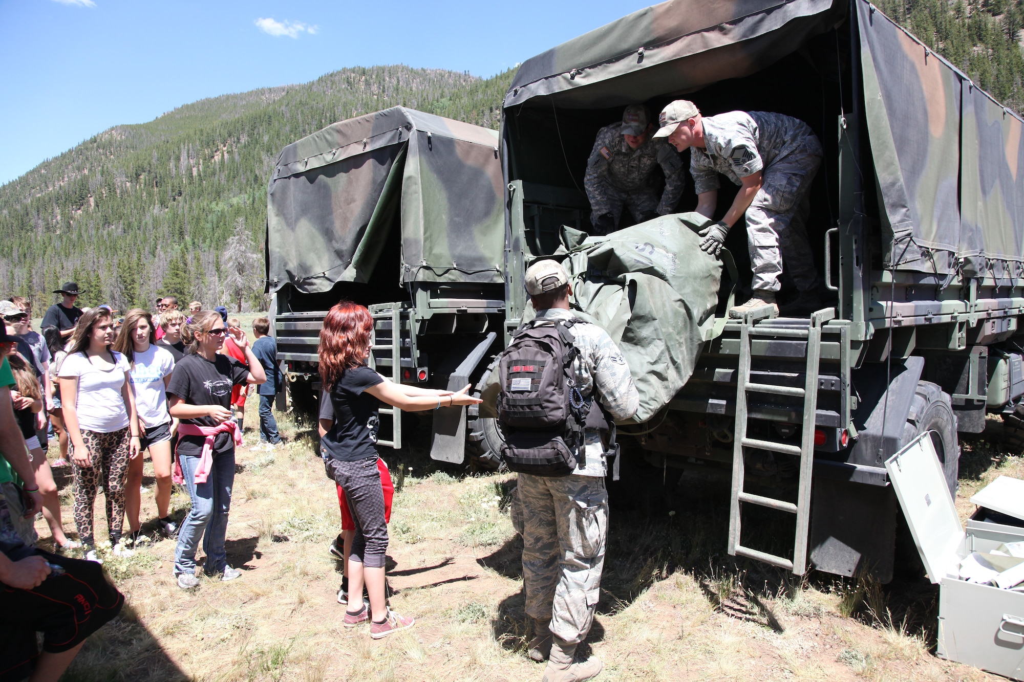 Teens line up to help unload tents and sleeping bags during the week-long Laramie River Valley Rendezvous program near Ft. Collins, Colo. July 6-12. The kids, who are identified as being high-risk for potential drug use, participate in various games and activities throughout the week and are mentored by members of the Colorado National Guard. (U.S. Air National Guard Photo by Tech. Sgt. B. Kevin Coulter) 