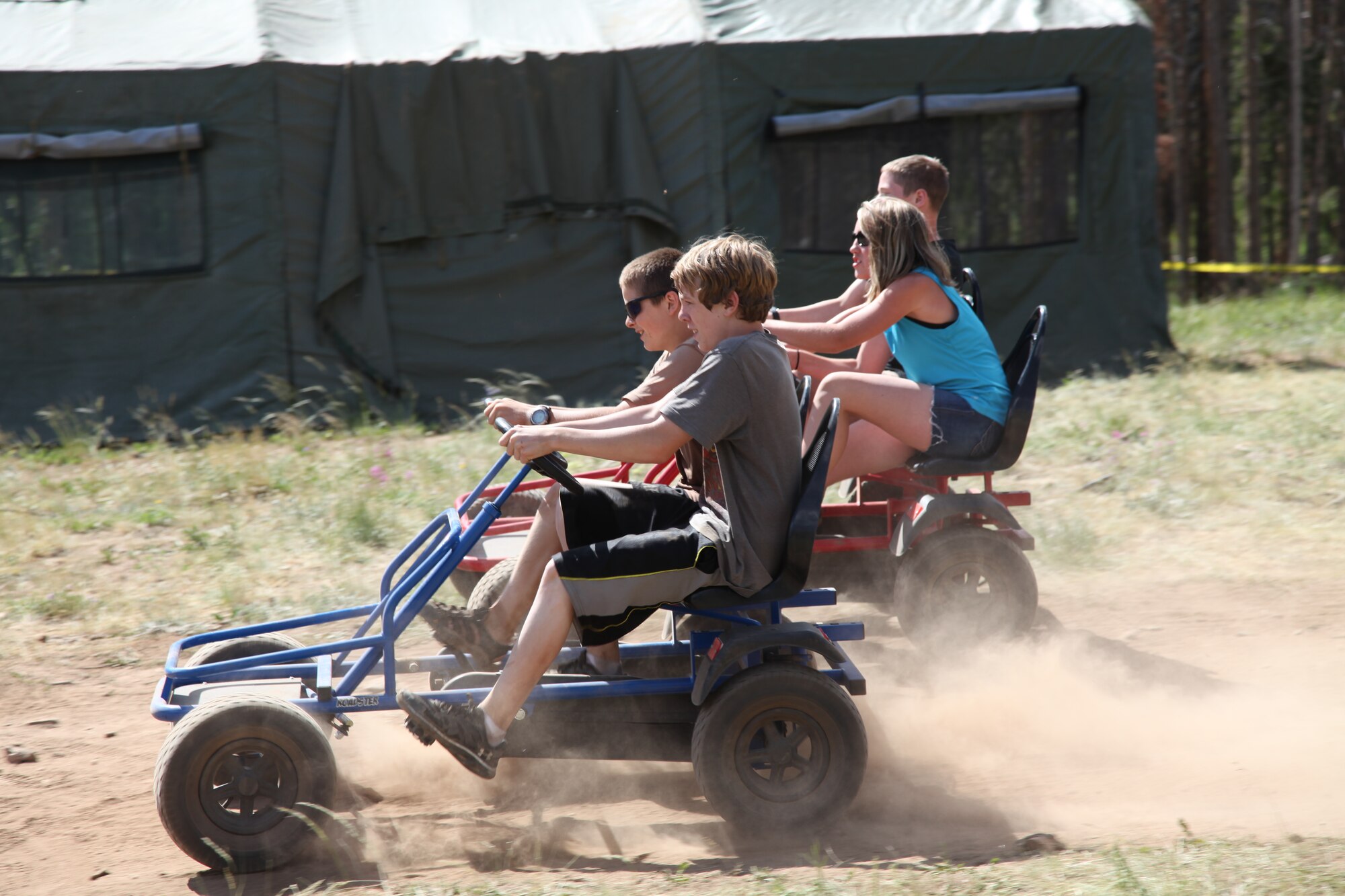 Teens race on pedal carts during the week-long Laramie River Valley Rendezvous program near Ft. Collins, Colo. The kids, who are identified as being high-risk for potential drug use, participate in various games and activities throughout the week and are mentored by members of the Colorado National Guard. (U.S. Air National Guard Photo by Tech. Sgt. B. Kevin Coulter) 