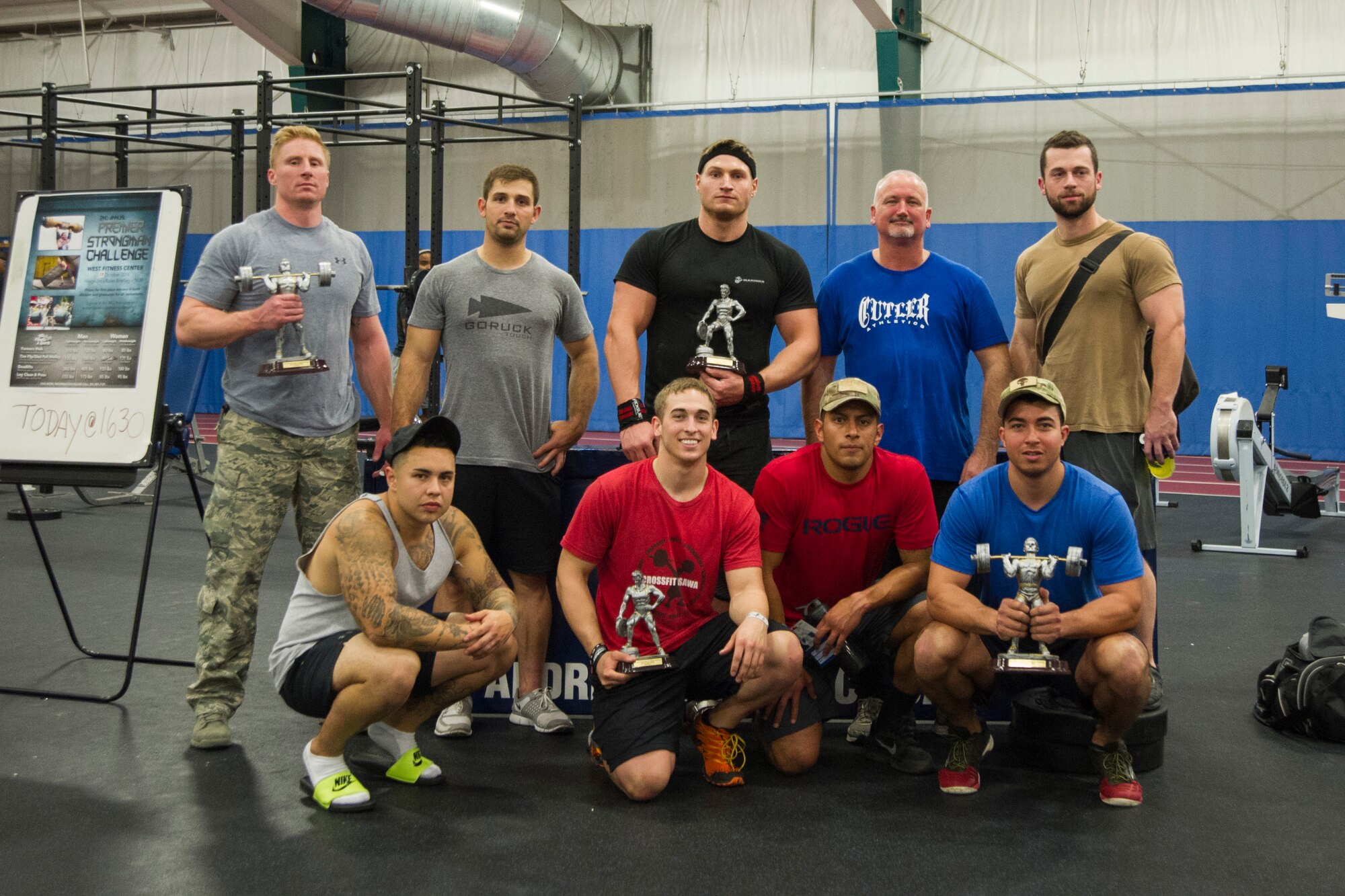 The male competitors of the 2nd Annual Premier Strongman Challenge pose for a photo after the event at the West Fitness Center on Joint Base Andrews, Md., Oct. 28, 2014. The challenge consisted of a tire flip and sled-pull medley, a farmer’s walk, deadlifts, and a log and clean press. (U.S. Air Force photo/Airman 1st Class Ryan J. Sonnier)