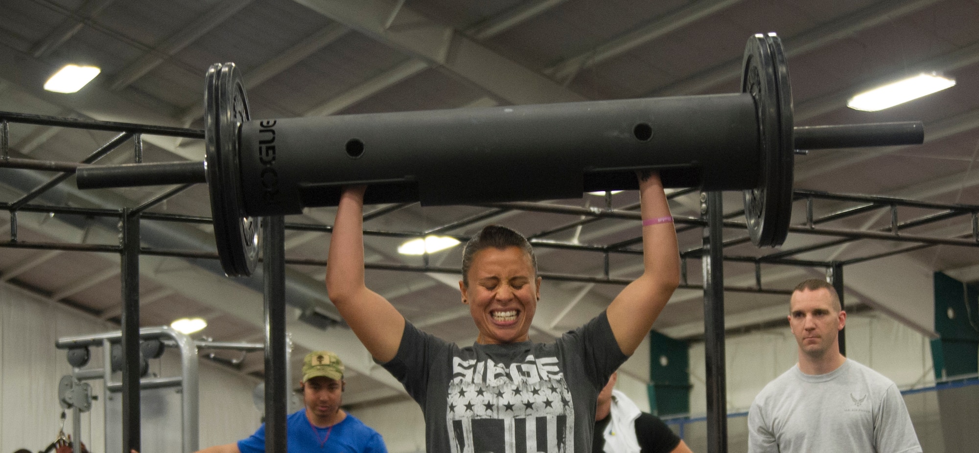 Staff Sgt. Charlemagne Cameron, an 11th Security Forces Squadron military working dog handler, lifts 85 pounds for the log clean and press during the 2nd Annual Premier Strongman Challenge at the West Fitness Center on Joint Base Andrews, Md., Oct. 28, 2014. Cameron went on to win in her weight class for the competition. (U.S. Air Force photo/Airman 1st Class Ryan J. Sonnier)