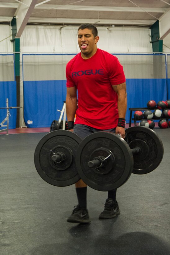 Staff Sgt. Peter Velez, an 811th Security Forces Squadron executive aircraft security member, carries 135 pounds for the farmer’s walk during the 2nd Annual Premier Strongman Challenge at the West Fitness Center on Joint Base Andrews, Md., Oct. 28, 2014. Velez was one of seven men to compete in the lightweight class. (U.S. Air Force photo/Airman 1st Class Ryan J. Sonnier)