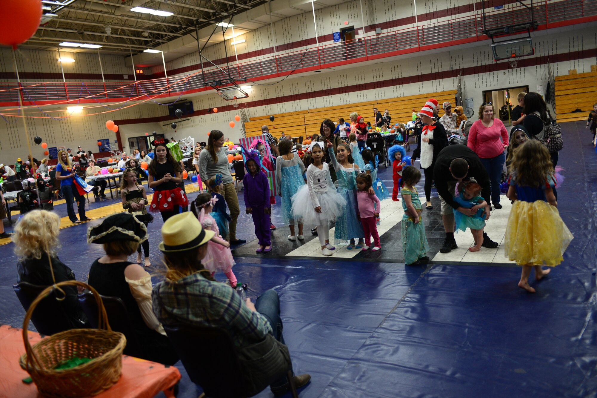 Children participate in a costume contest during the Halloween Kids Carnival in the Bellamy Fitness Center at Ellsworth Air Force Base, S.D., Oct. 25, 2014. Airmen and families gathered to enjoy a night of fun, face painting, costume contests, prizes, and more. (U.S. Air Force photo by Senior Airman Zachary Hada/Released)
