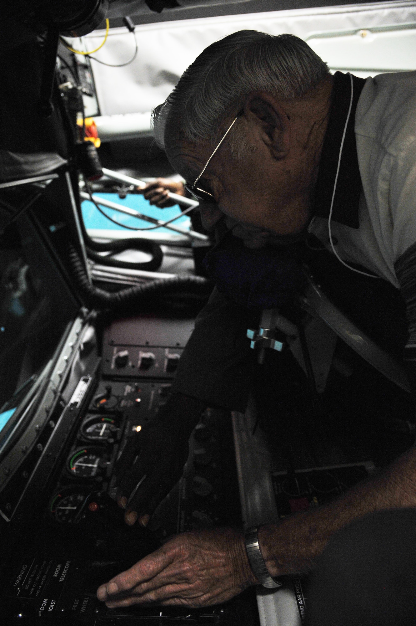 Air Force Retired Charles Lynch, Inflight Refueling Association member, operates the Boom Operator Weapons Systems  Trainer simulator for the first time Oct. 24, 2014, at MacDill Air Force Base, Fla. Lynch was trained as a boom operator in the 1950s on a KC-97 Tanker and served during World War II, Korean War and Vietnam War. (U.S. Air Force photo by Senior Airman Jenay Randolph/Released) 