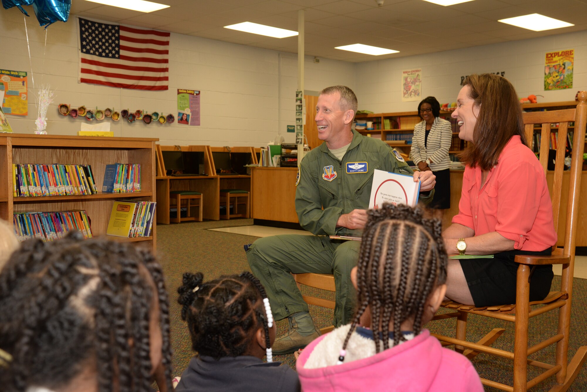 U.S. Air Force Col. Scott Caine, Ninth Air Force vice commander, and his wife, Pam, read to a group of first grade students at Cherryvale Elementary School, Sumter, S.C., Oct. 28, 2014. Approximately once a quarter, Ninth Air Force leadership reads to local school students. (U.S. Air Force photo by Airman 1st Class Jonathan Bass/Released)
