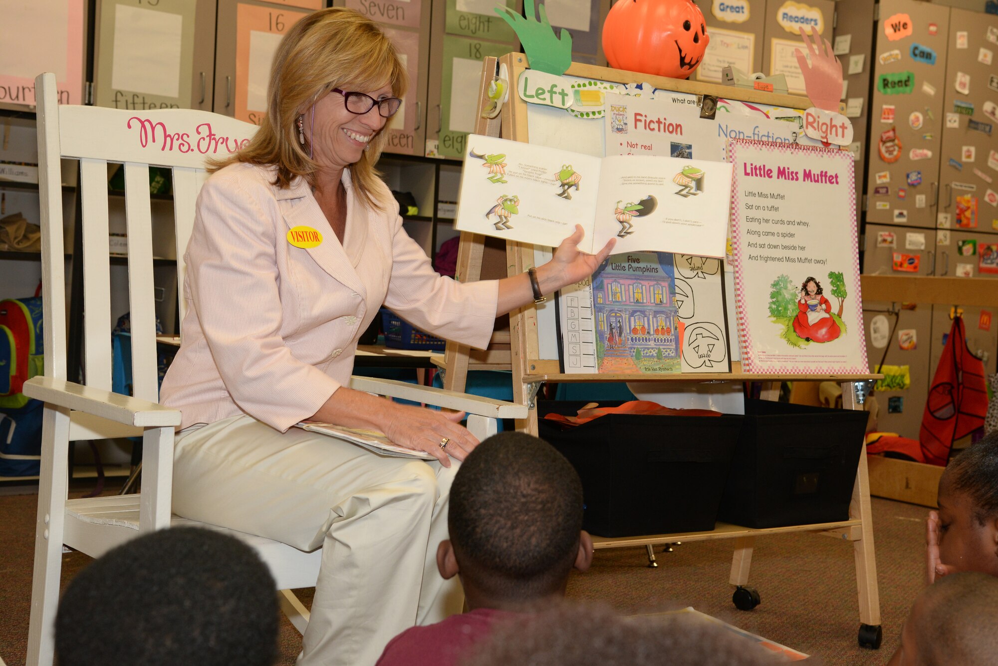 Sandra Polumbo, the wife of Maj. Gen. H.D. Polumbo Jr., Ninth Air Force commander, reads to a group of kindergarten students at Alice Drive Elementary School, Sumter, S.C., Oct. 27, 2014. The Polumbos and several other members of the Ninth Air Force headquarters staff visited schools in the Sumter area to read to students and talk about serving in the Air Force. (U.S. Air Force photo by Airman 1st Class Jonathan Bass/Released)