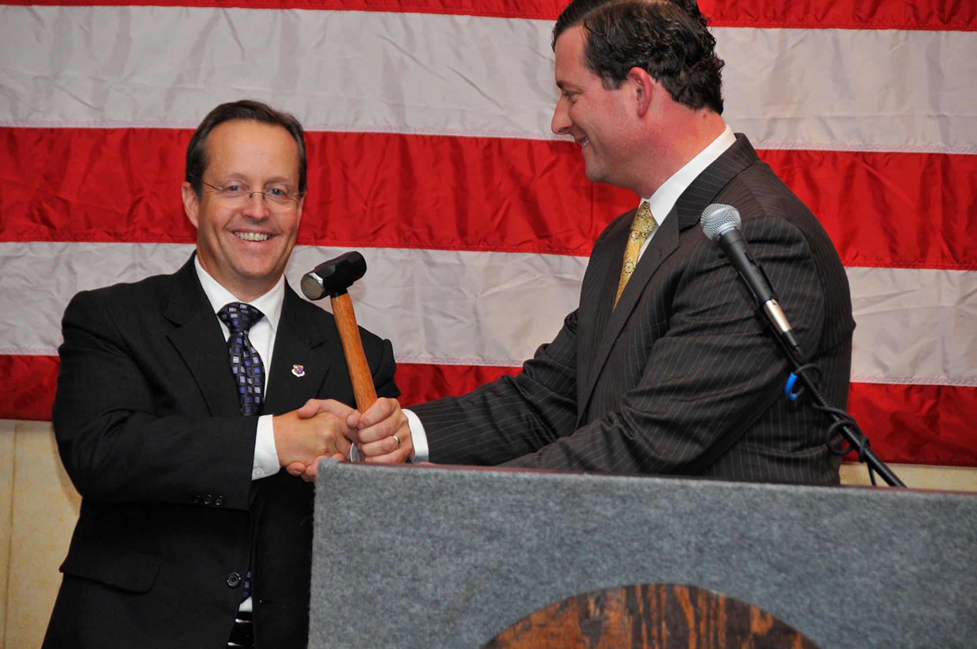 Arnold Community Council (ACC) 2015 President Jim Jolliffe (left) accepts the gavel from former ACC President Ben Craig symbolizing the change in the ACC leadership. The change took place at the ACC Annual Dinner in Manchester on Oct. 23. (Photo by Rick Goodfriend)