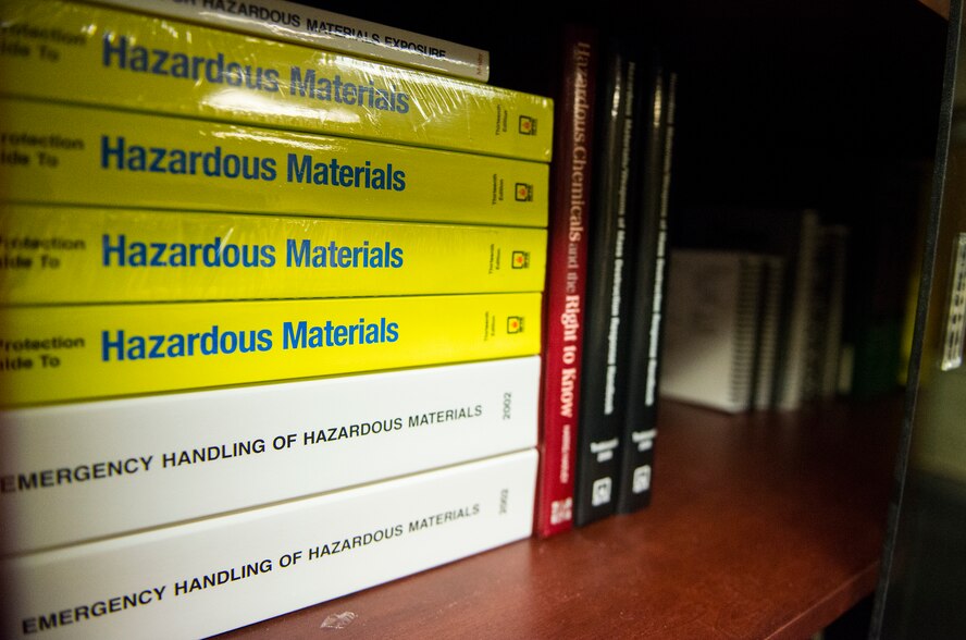 Hazardous materials instruction manuals rest on a book shelf Oct. 29, 2014, at Moody Air Force Base, Ga. The 23d Civil Engineer Squadron firefighters use manuals to determine proper handling protocol for hazardous materials. (U.S. Air Force photo by Airman 1st Class Ceaira Tinsley/Released)