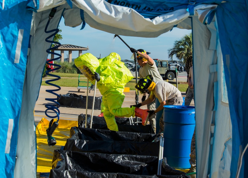 U.S. Air Force Senior Airman Benjamin Jacobson, 23d Civil Engineer Squadron operator, gets scrubbed during a simulated hazardous material decontamination line Oct. 29,2014, at Moody Air Force Base, Ga. The decontamination line scrubbed Jacobson three times and each time they removed one piece of his safety gear. (U.S. Air Force photo by Airman 1st Class Ceaira Tinsley/Released)