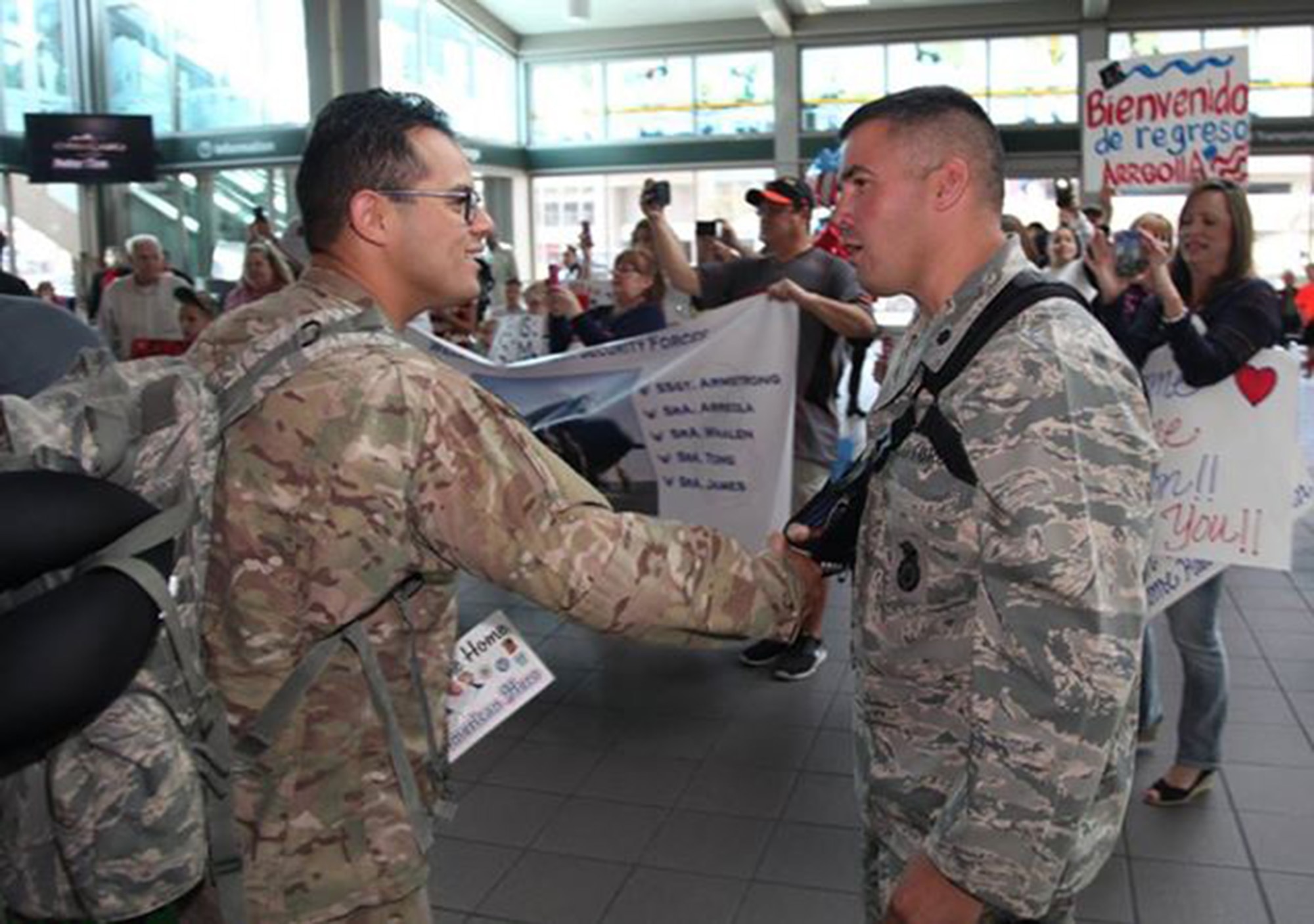 TRAVIS AIR FORCE BASE, Calif. -- Family and friends greet Defenders from the 349th Security Forces Squadron returning from Southwest Asia at Sacramento International Airport, Calif., Oct. 29, 2014. (U.S. Air Force photo/Lt. Col. Robert Couse-Baker) 
