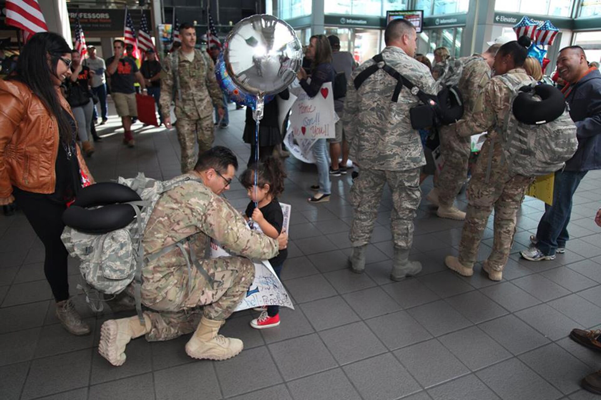 TRAVIS AIR FORCE BASE, Calif. -- Family and friends greet Defenders from the 349th Security Forces Squadron returning from Southwest Asia at Sacramento International Airport, Calif., Oct. 29, 2014. (U.S. Air Force photo/Lt. Col. Robert Couse-Baker) 